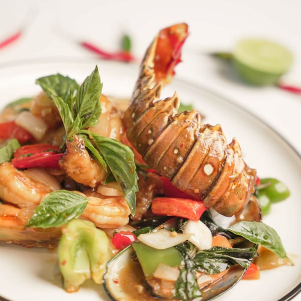 Noi Thai Cuisine's spicy seafood stir-fry with lobster tail, shrimp, mussels, and fresh basil.